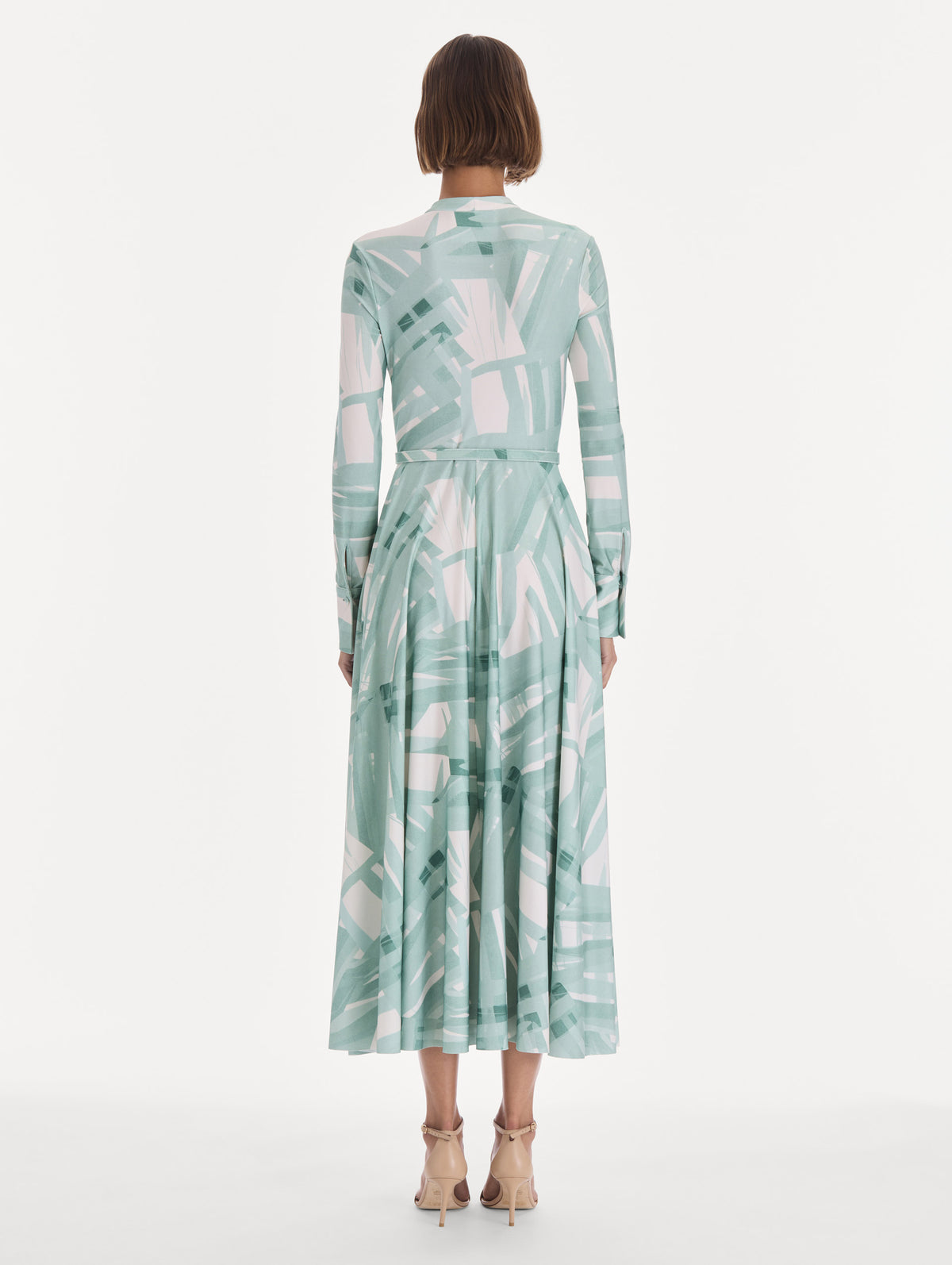 The model is wearing a long sleeve stripey plaid jersey day dress. Back view.