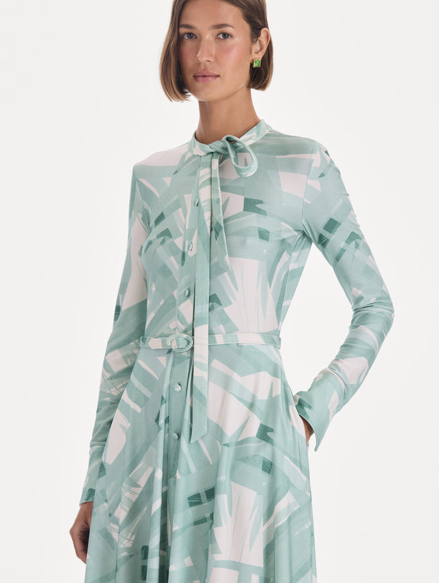 The model is wearing a long sleeve stripey plaid jersey day dress. Zoom view.