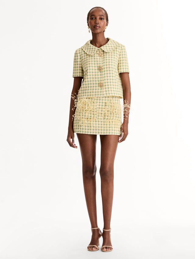 Short Sleeve Cropped Checked Tweed Jacket, Floral Button Closure, Butter Yellow with Green Checks, Rounded Collar. Front View.