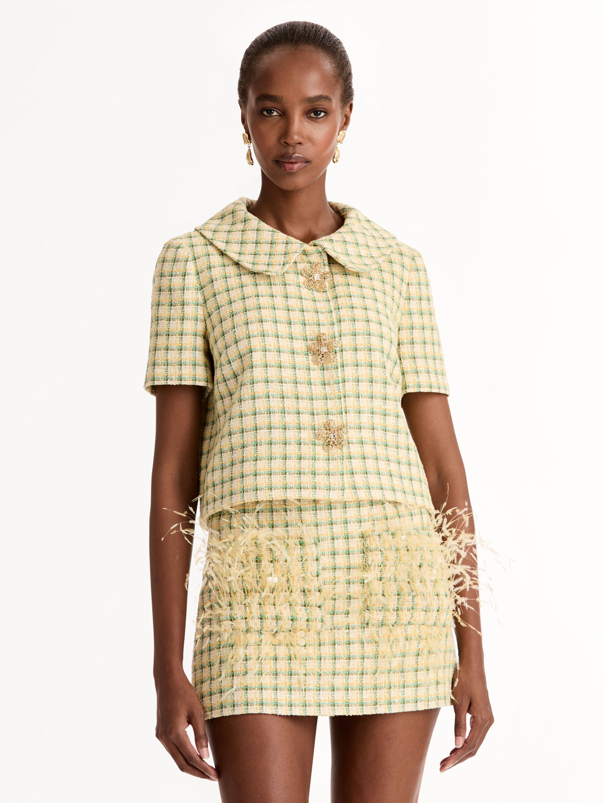 Short Sleeve Cropped Checked Tweed Jacket, Floral Button Closure, Butter Yellow with Green Checks, Rounded Collar. Front View.