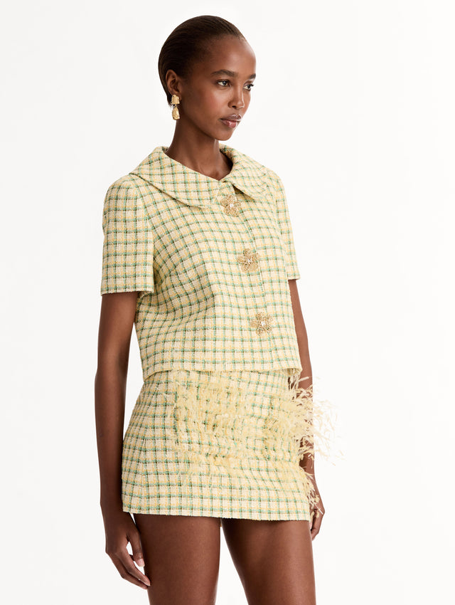 Short Sleeve Cropped Checked Tweed Jacket, Floral Button Closure, Butter Yellow with Green Checks, Rounded Collar. Side View.
