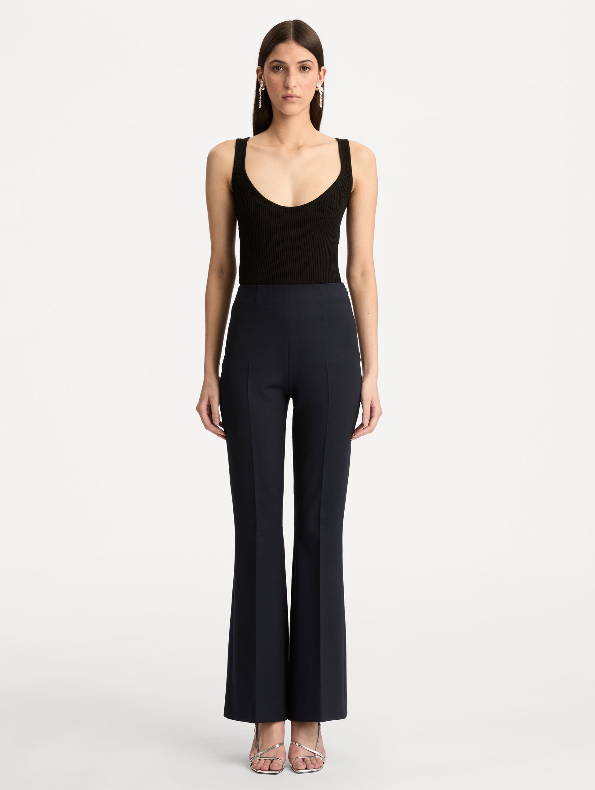 Navy Wool Flared Pants featuring a high waist, front crease detailing, and slightly flared hem. Front View.