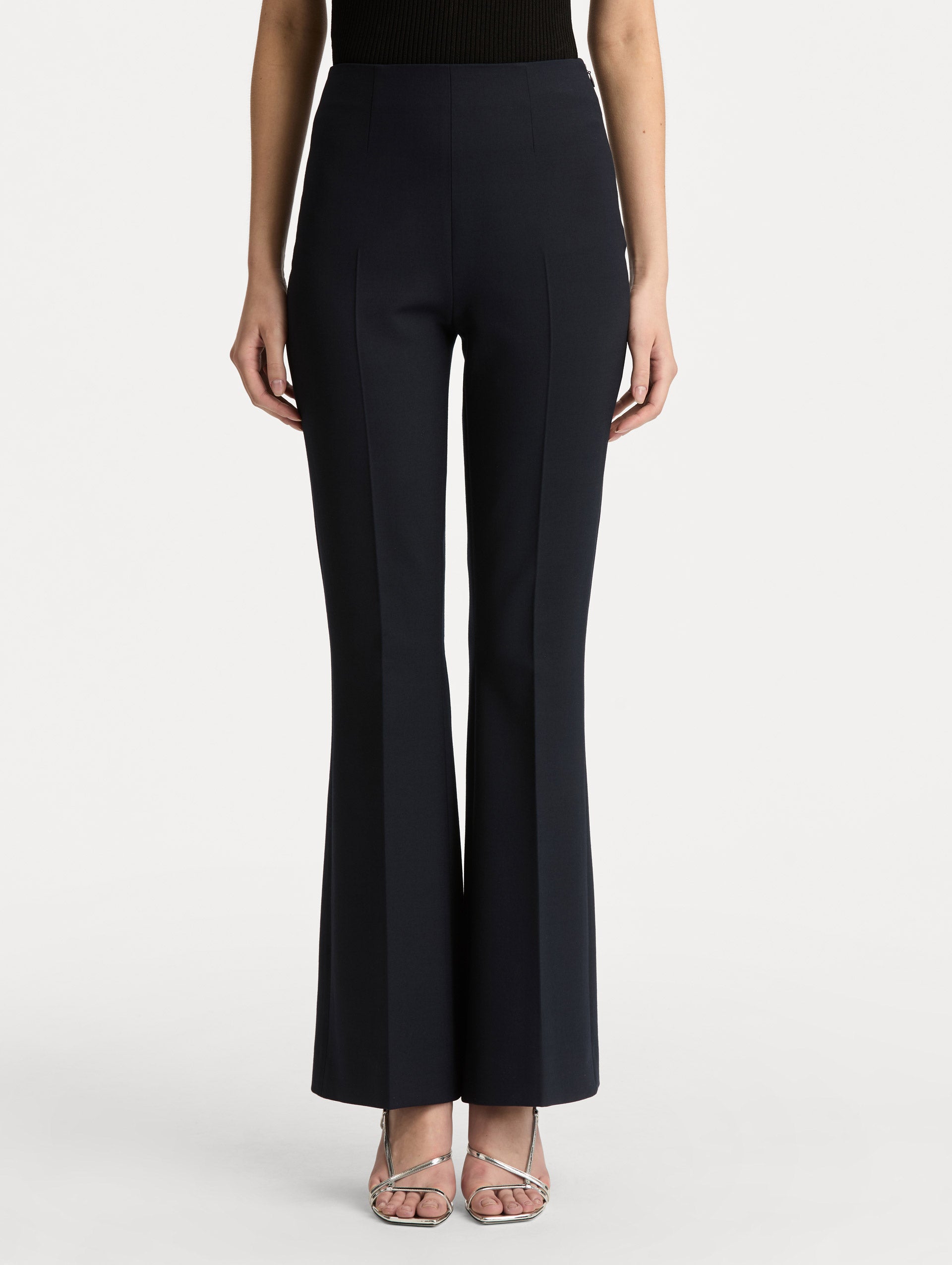 Navy Wool Flared Pants featuring a high waist, front crease detailing, and slightly flared hem. Front View.