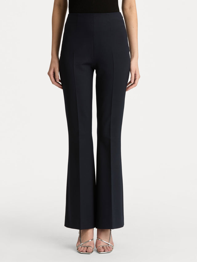 Navy Wool Flared Pants featuring a high waist, front crease detailing, and slightly flared hem. Front View.