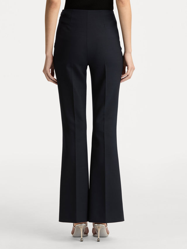 Navy Wool Flared Pants featuring a high waist, front crease detailing, and slightly flared hem. Back View.