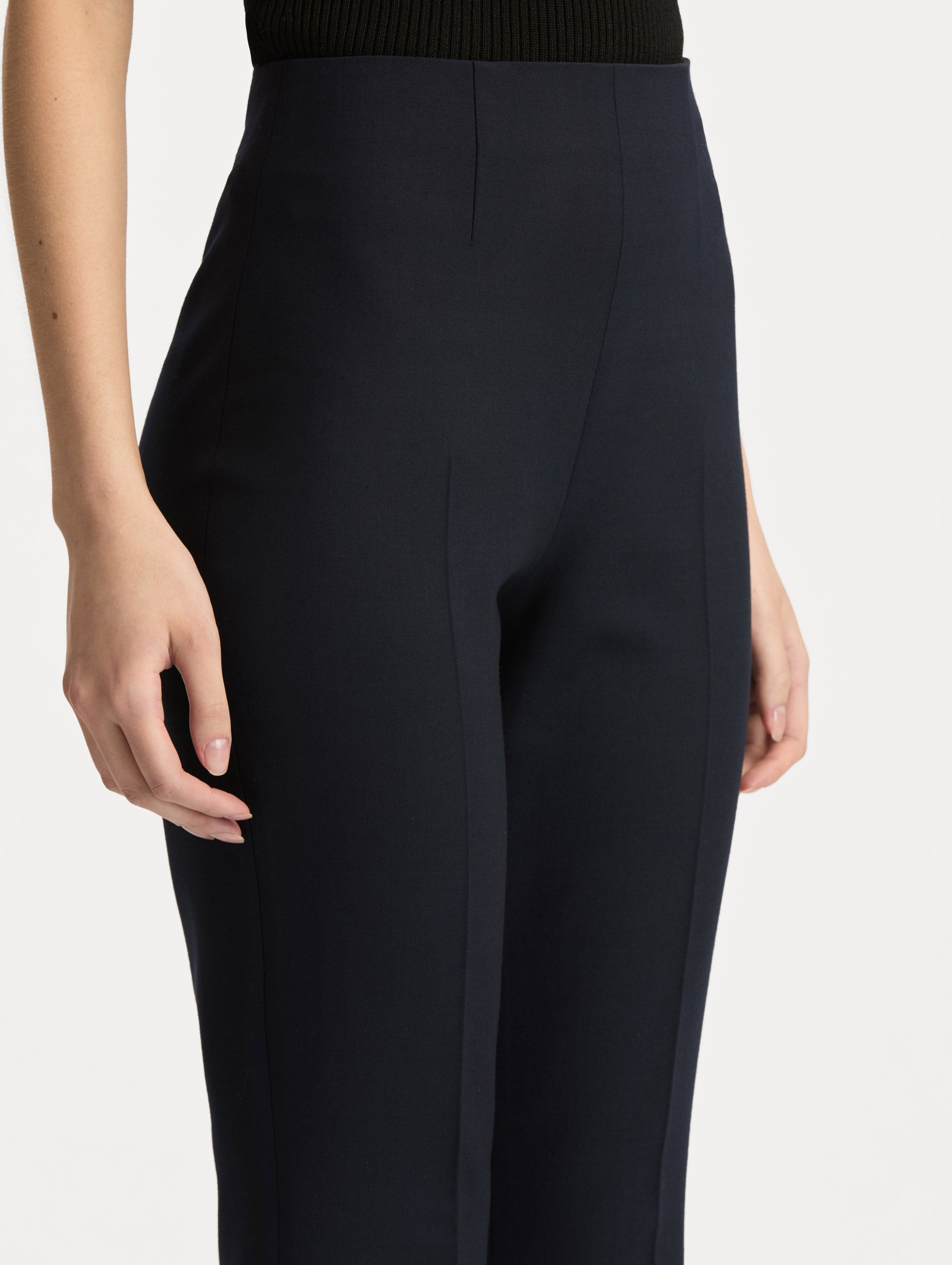 Navy Wool Flared Pants featuring a high waist, front crease detailing, and slightly flared hem. Zoom View.