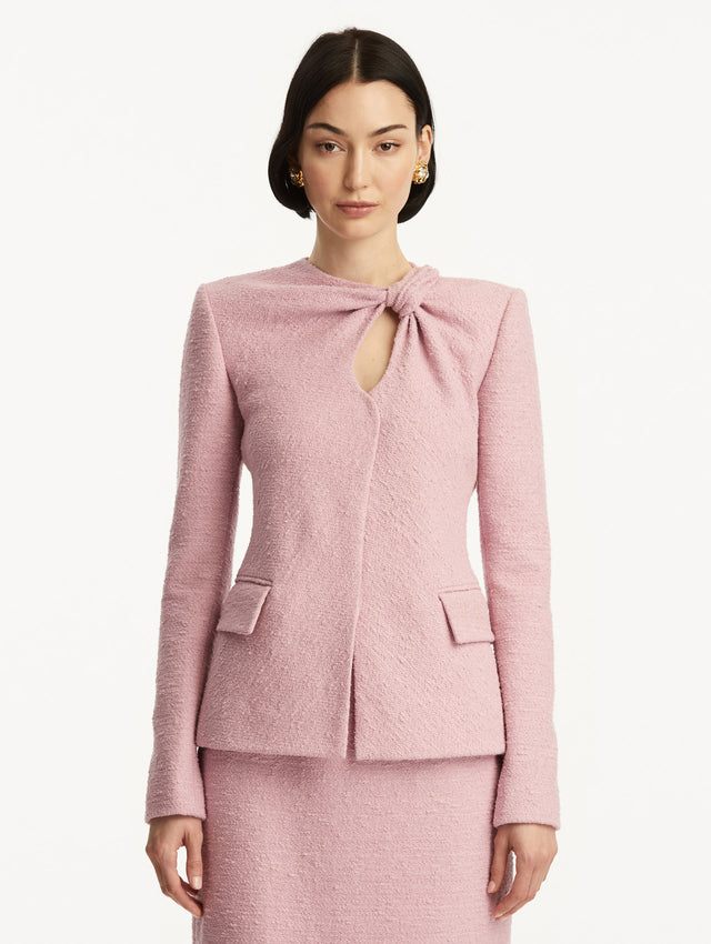 Light pink tweed jacket with a twist detail in the top corner. Front View.
