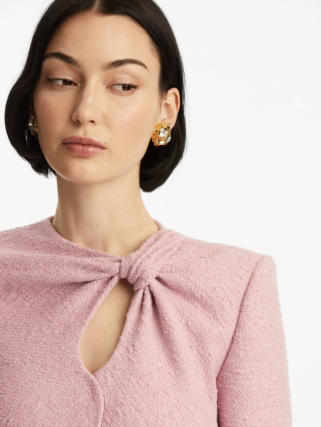 Light pink tweed jacket with a twist detail in the top corner. Zoom view.