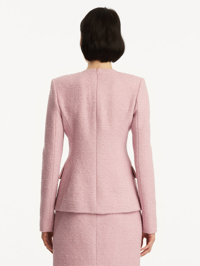Light pink tweed jacket with a twist detail in the top corner. Back View.