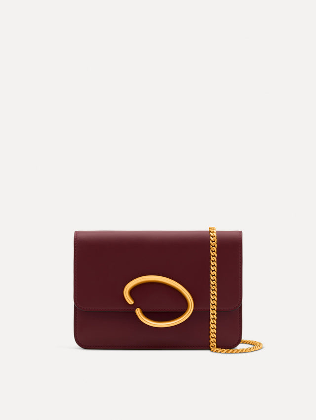 Maroon O Pochette with gold hardware and abstract O Clasp. Front View. 