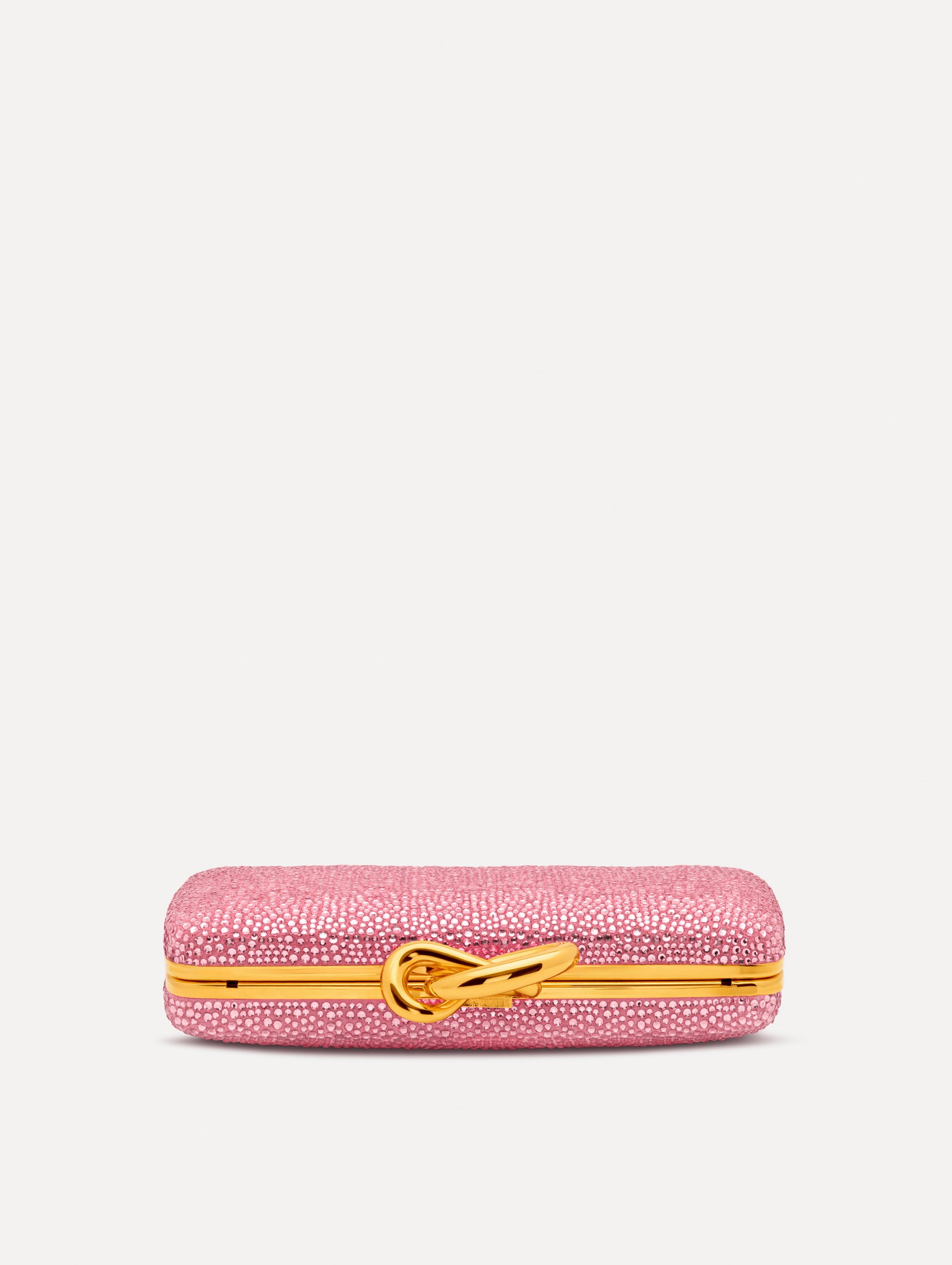Pink Crystal Pavé Knot Minaudière featuring a rectangular silhouette, allover pavé embellishment, and sculptural gold knot clasp.