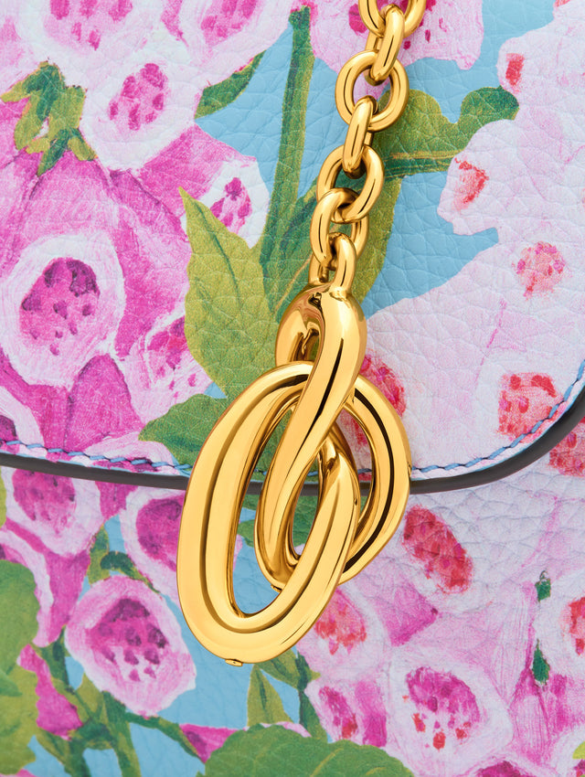 Gold Knotted Bag Charm with chain drop ending in an interlocking knot charm. Zoom View.