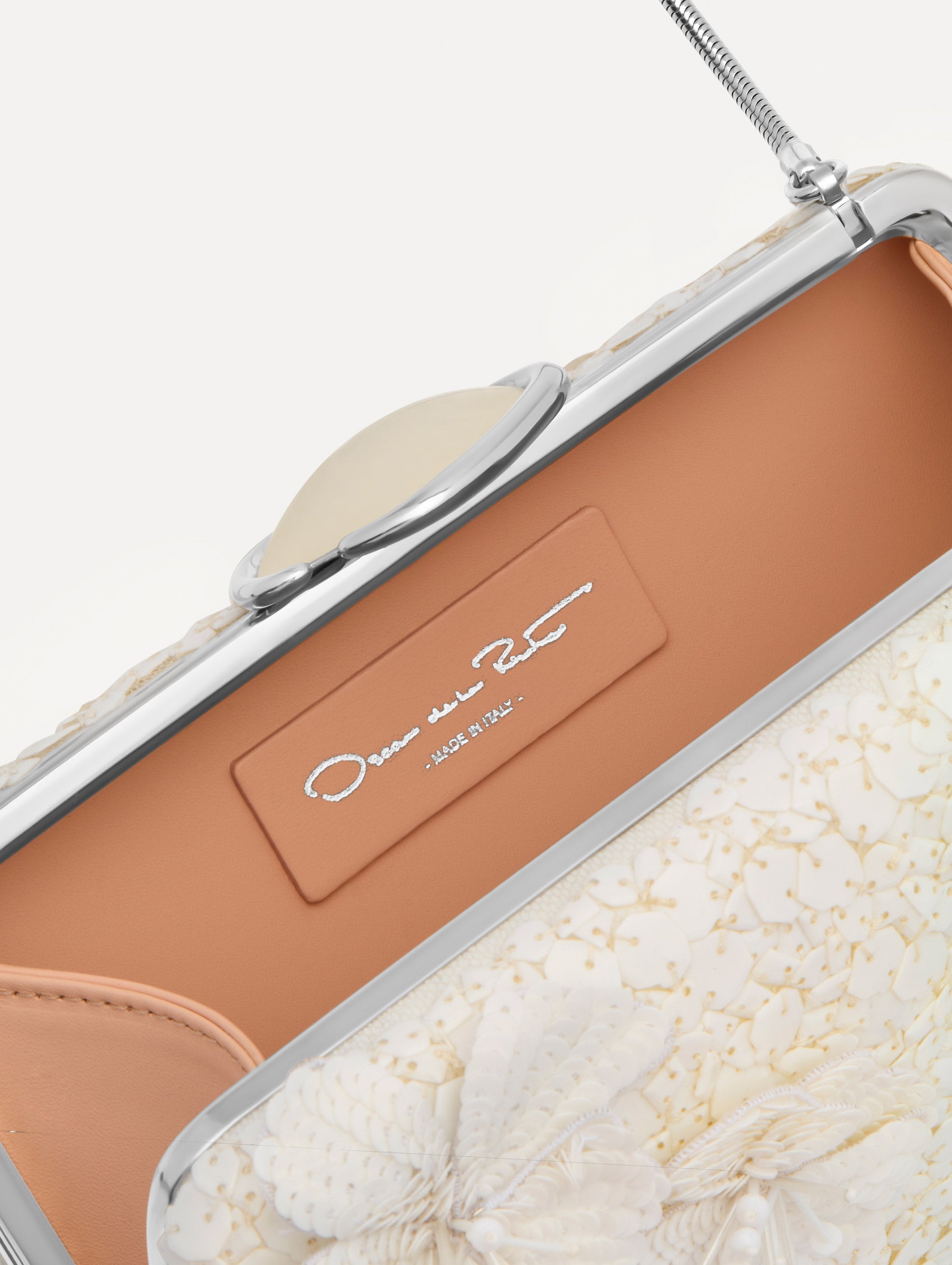 White Cherry Blossom Embroidered O Minaudière featuring a rectangular silhouette, beaded surface, and oversized three-dimensional flower embellishments.