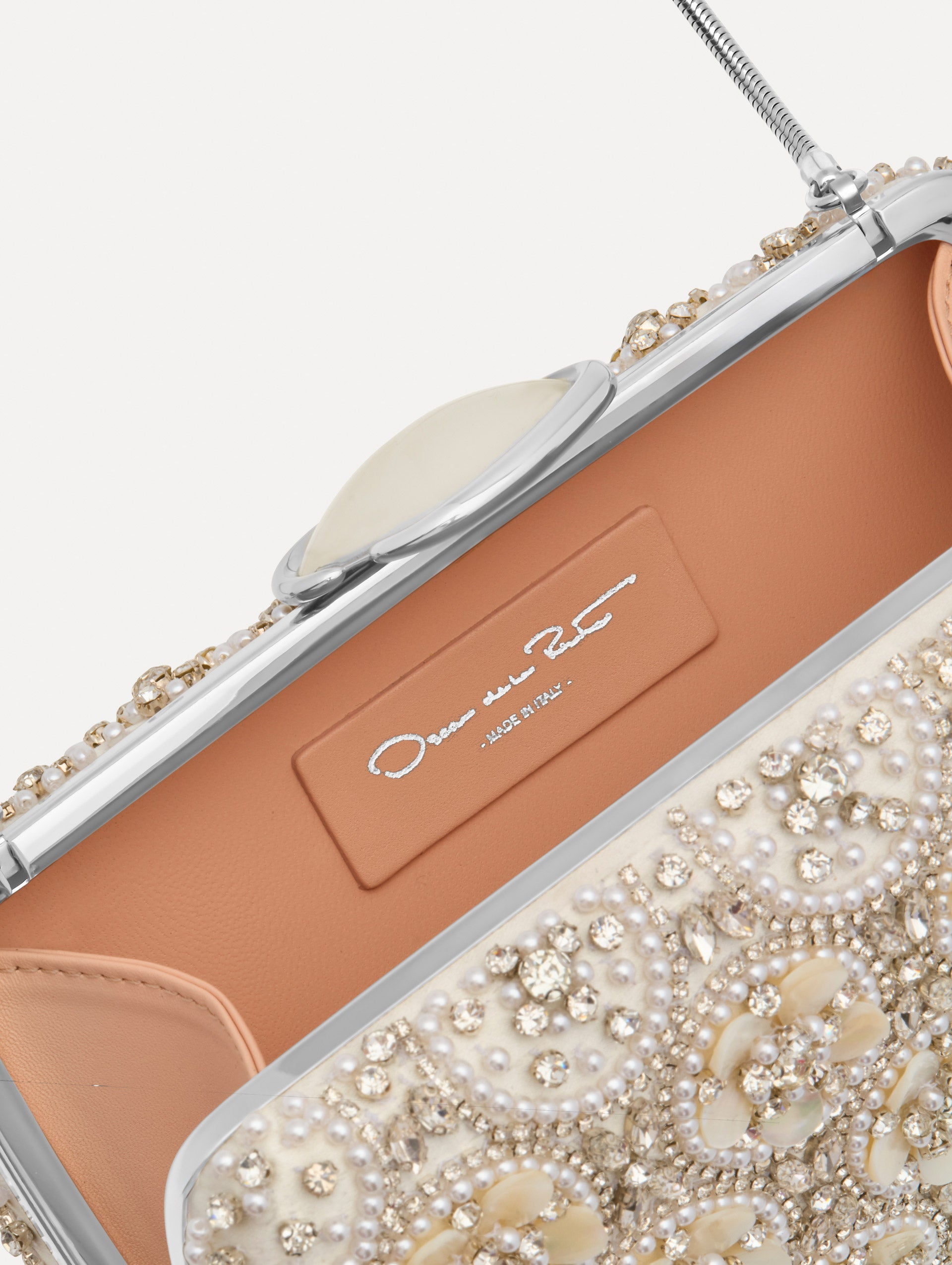 Ivory Mother of Pearl Embroidered O Minaudière featuring ivory beaded flowers, crystal detailing, and a structured rectangular silhouette with top clasp closure. Zoom View.