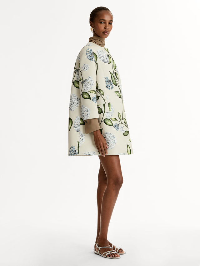 Floral Porcelain Flower Faille Coat in ivory, blue and green. Button closure with long sleeves. Side View. 