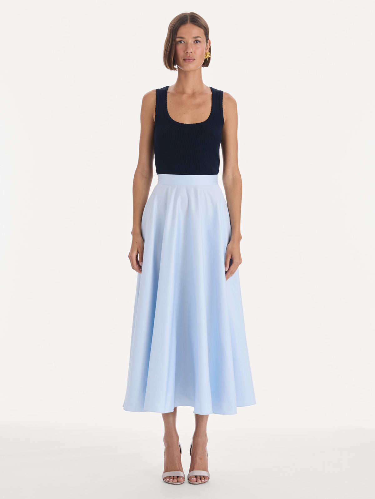 The model is wearing a cotton poplin sateen circle skirt. Front view.