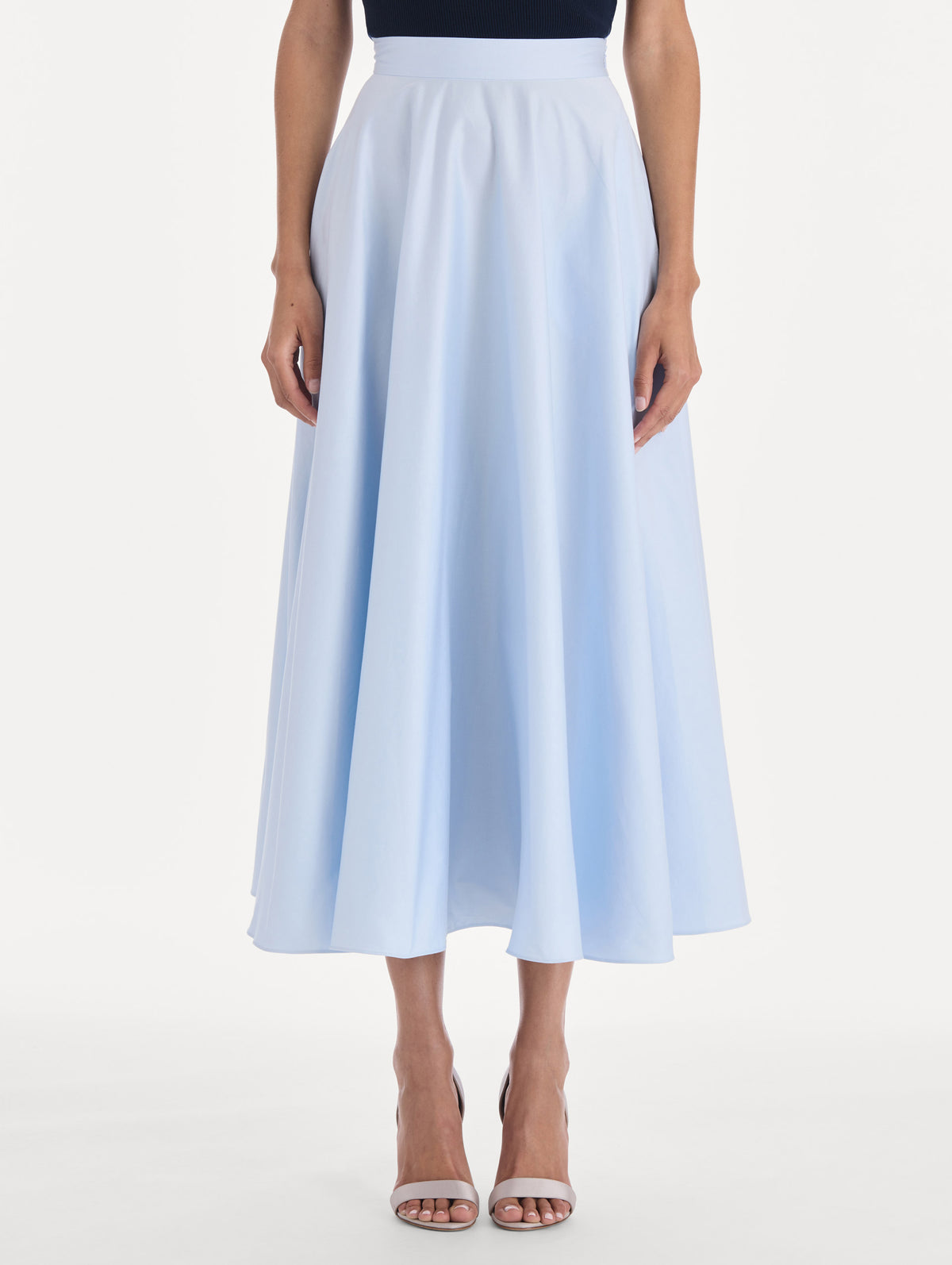 The model is wearing a cotton poplin sateen circle skirt. Side view.