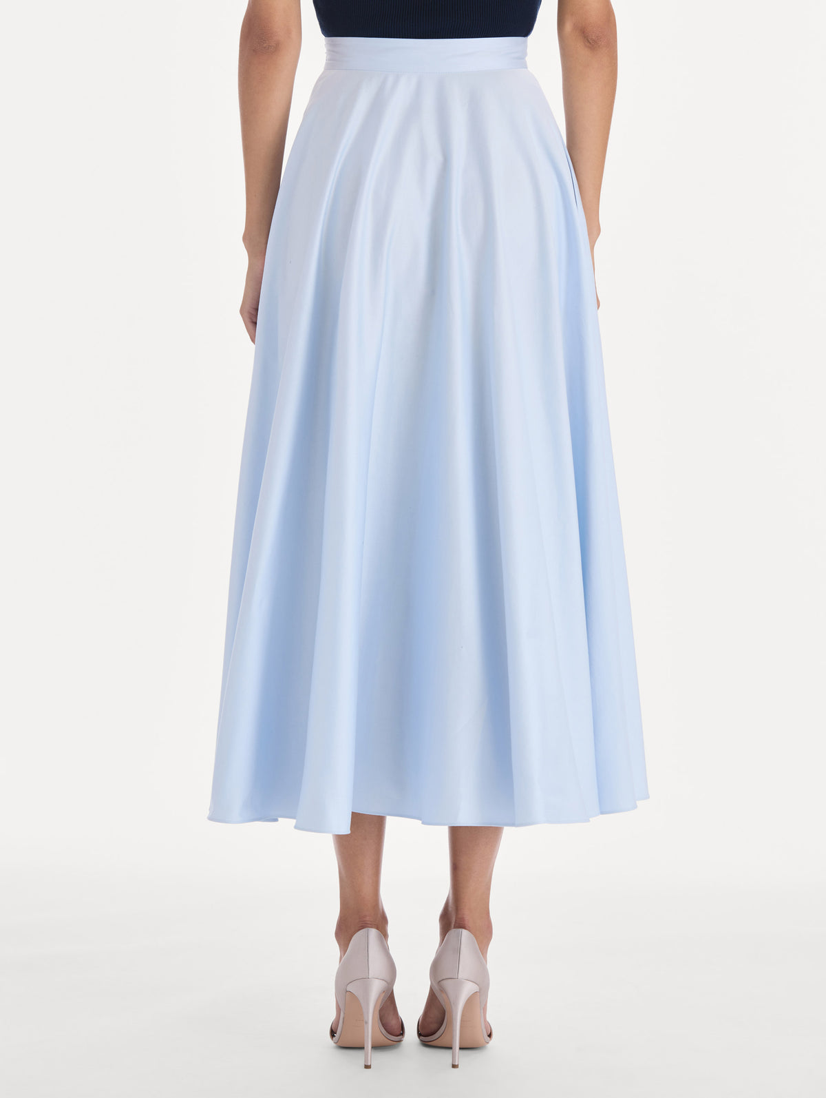 The model is wearing a cotton poplin sateen circle skirt. Back view.