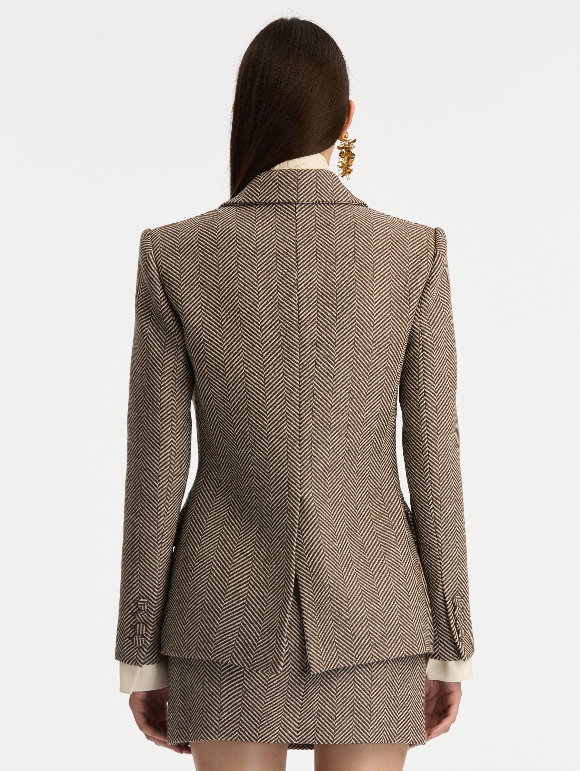 Brown and Ivory Chevron Cashmere-Blend Jacket featuring peak lapels, flap pockets, tailored seams, and gold floral buttons. Back View.