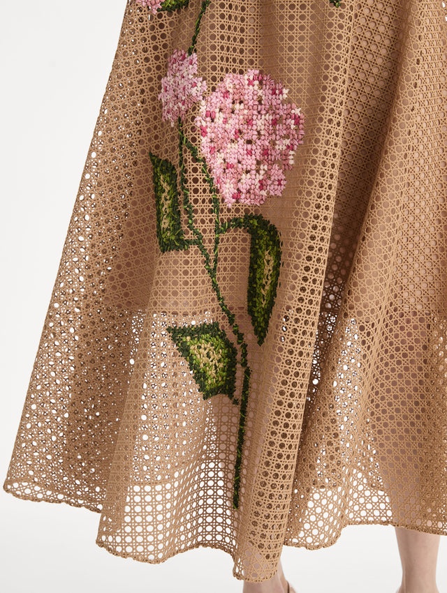 Porcelain flowers stitched with dimensional threadwork into an openwork lattice. Fitted bodice and flared skirt. Front View, Close Up of Skirt.