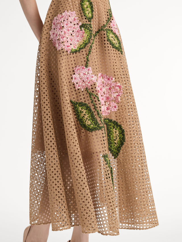 Porcelain flowers stitched with dimensional threadwork into an openwork lattice. Fitted bodice and flared skirt. Side View, Close Up of Skirt.