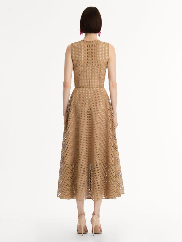 Porcelain flowers stitched with dimensional threadwork into an openwork lattice. Fitted bodice and flared skirt. Back View.