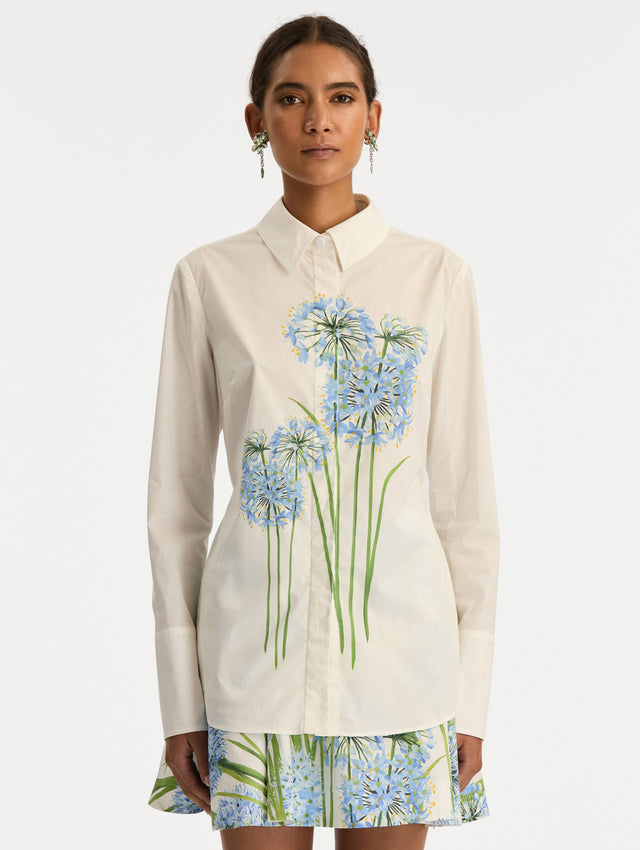 Ivory Allium Cotton Poplin Blouse with long sleeves and blue floral embroidery on the front. Front View.