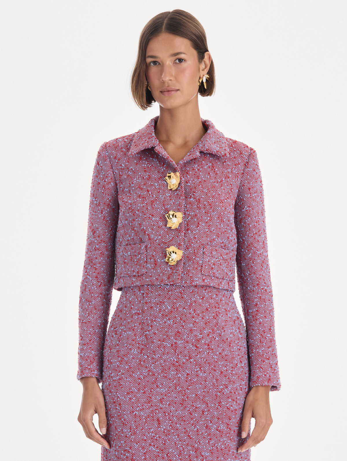 The model is wearing a long sleeve slubby wool tweed gauze jacket. Front view.