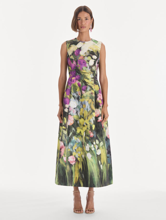 The model is wearing a sleeveless abstract garden faille cocktail dress. Front view.