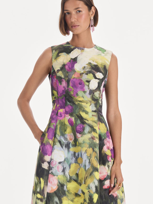 The model is wearing a sleeveless abstract garden faille cocktail dress. Zoom view.