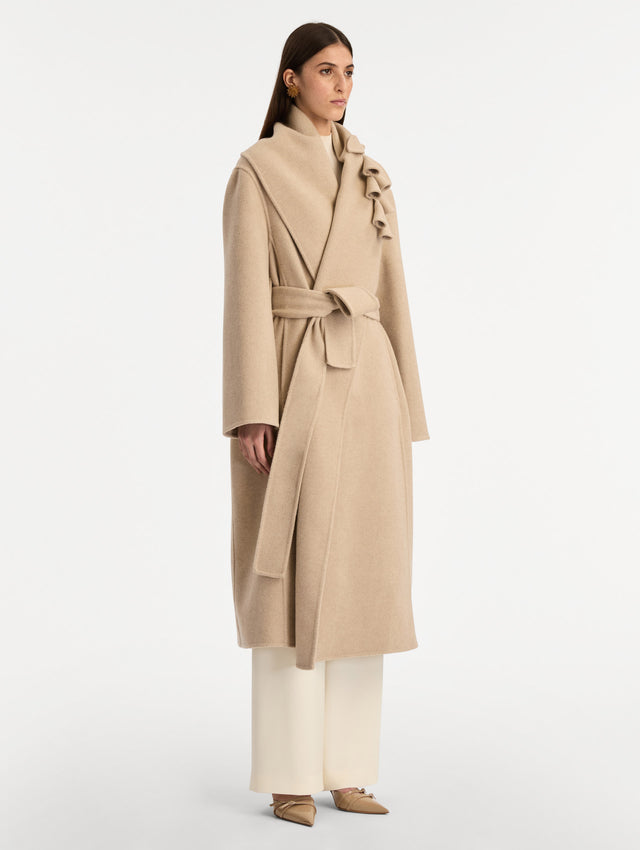 Beige Foxglove Embroidered Wool Coat with floral detail on the lapel and thick wool belt. Side View.