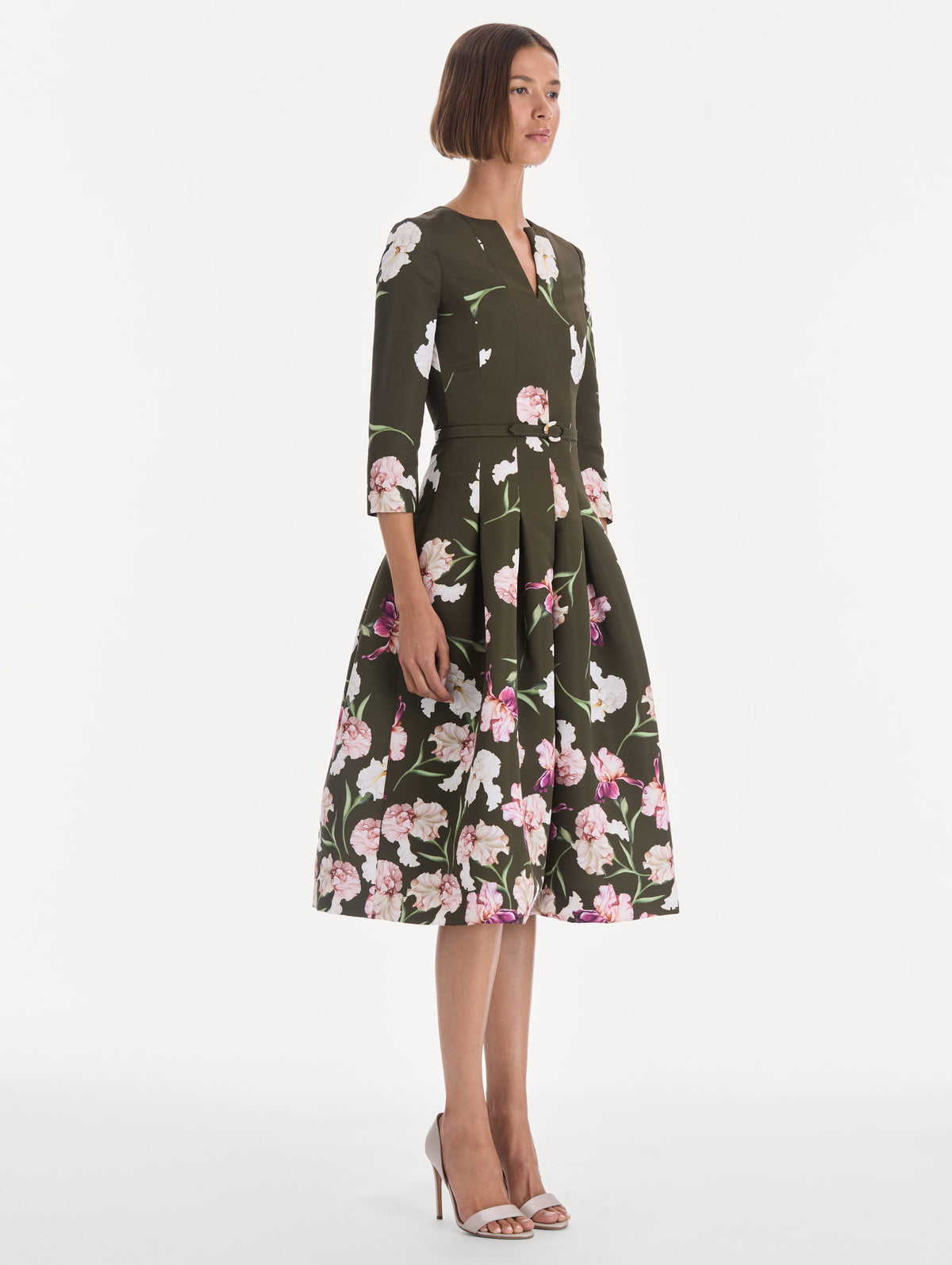 The model is wearing a long sleeve painted iris degrade faille cocktail dress. Side view.