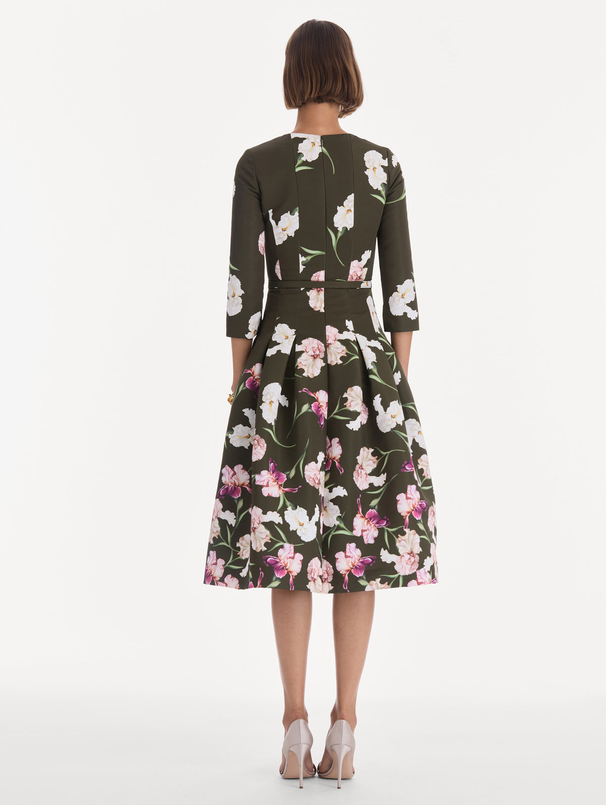 The model is wearing a long sleeve painted iris degrade faille cocktail dress. Back view.