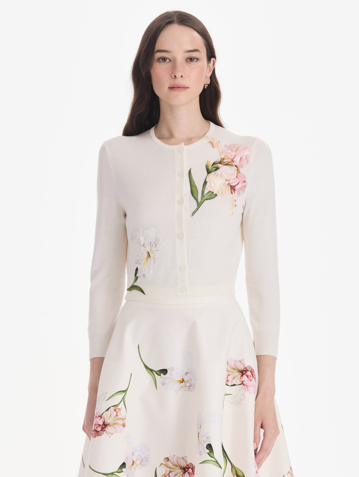 The model is wearing an embroidered cardigan. Front view.