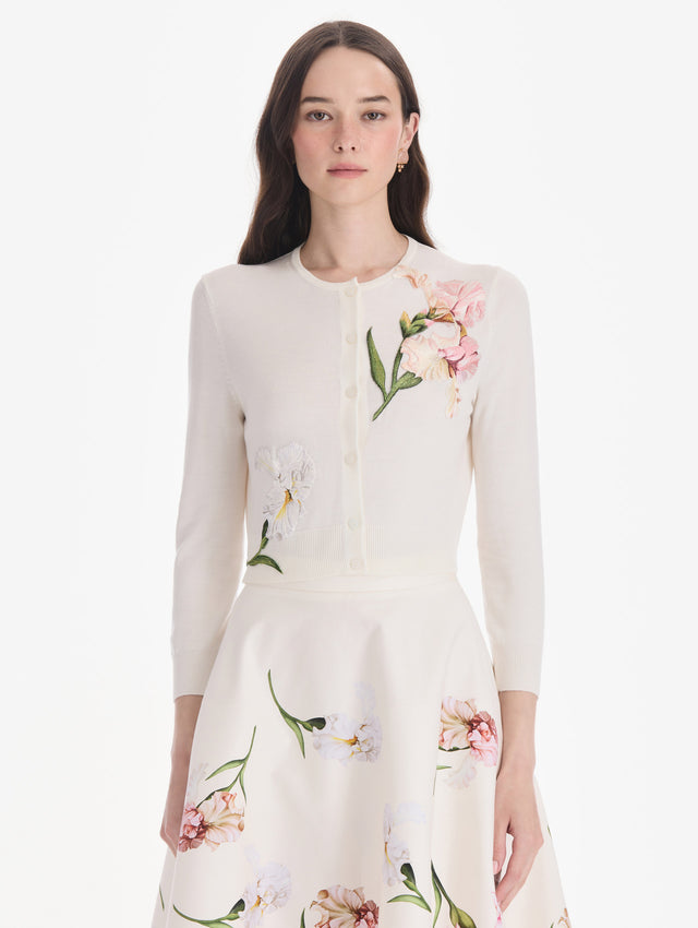 The model is wearing an embroidered cardigan. Front view.
