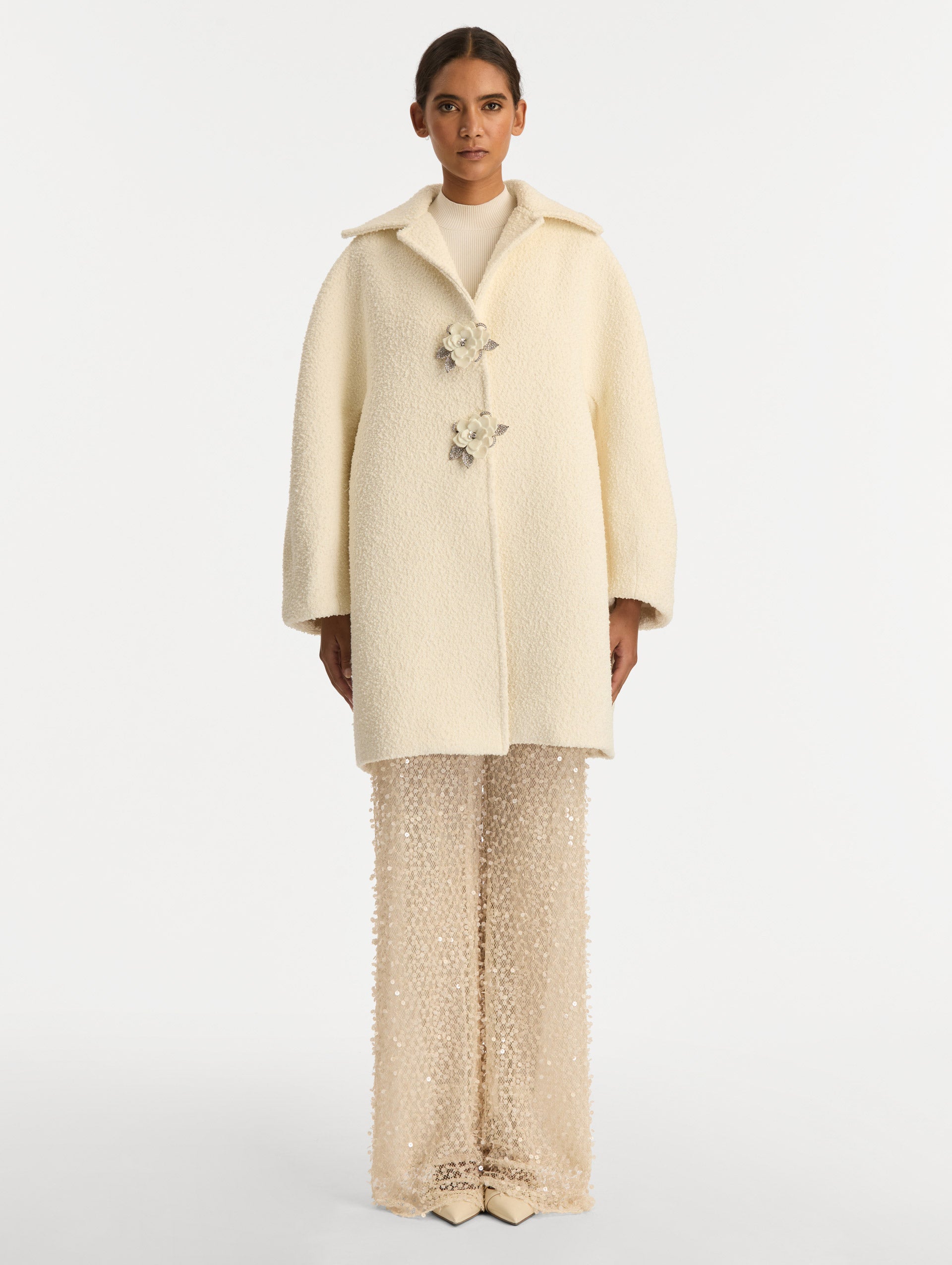 Ivory Floral Button Bouclé Tweed Coat with notched lapels, featuring two floral crystal-embellished clasps at the front. Front View.