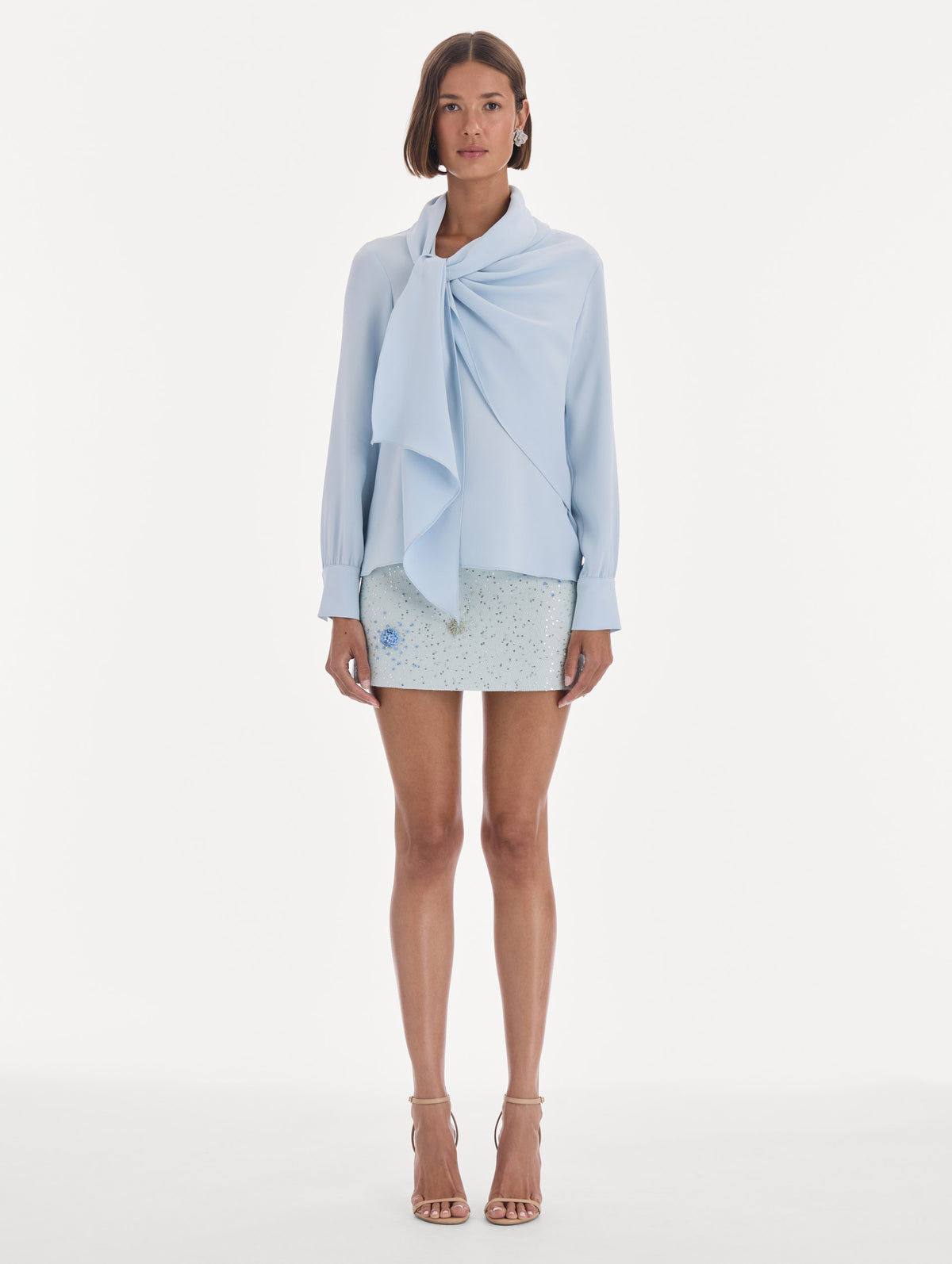 The model is wearing a long sleeve neck tie detail georgette blouse. Front view.