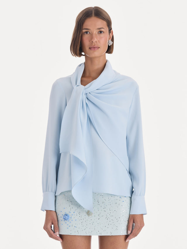 The model is wearing a long sleeve neck tie detail georgette blouse. Front view.