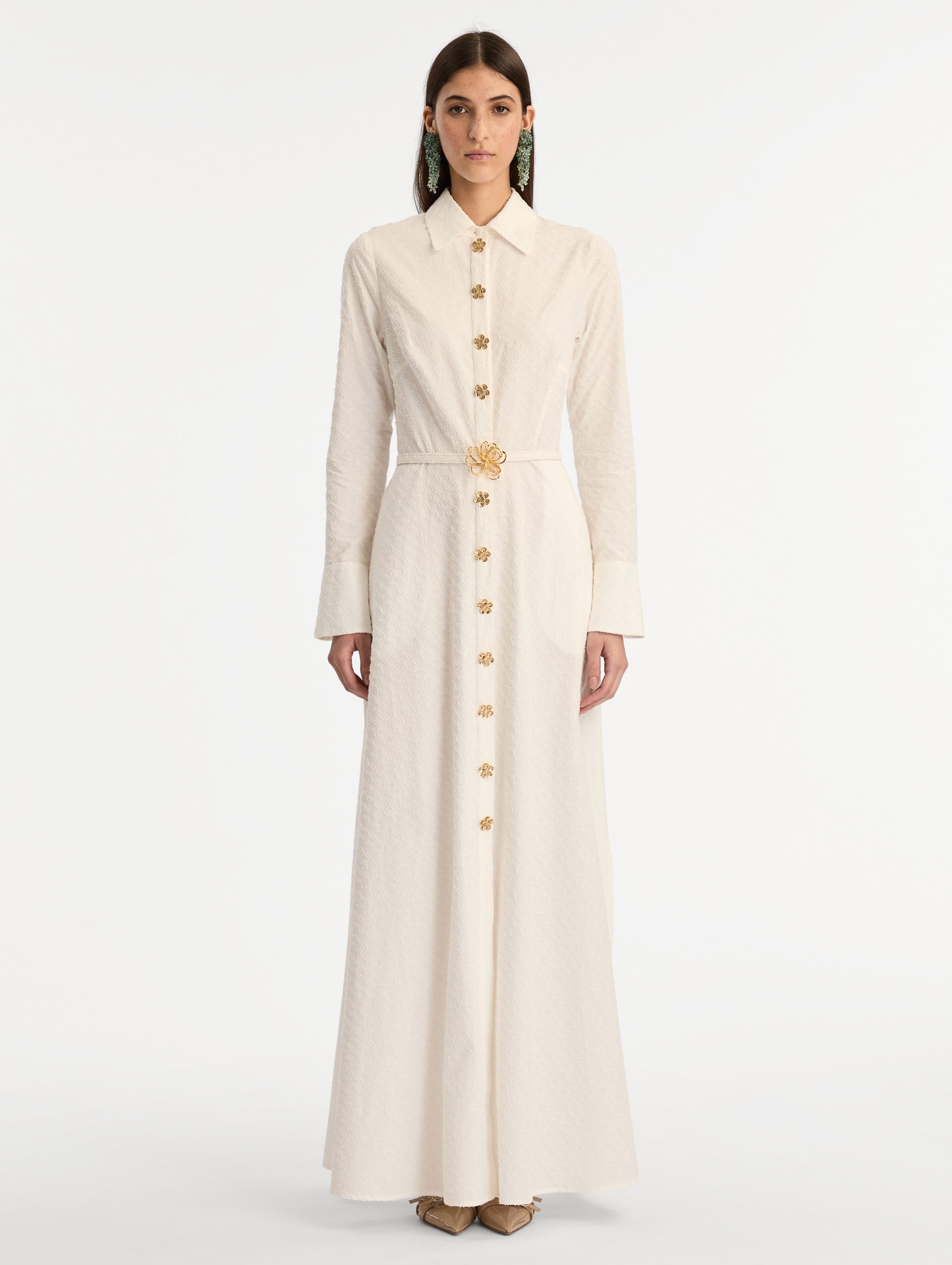 Ivory Oscar Chain-Link Cotton Poplin Caftan featuring a collared neckline, flared sleeves, gold button front, and belted waist with floral buckle. Front View. 