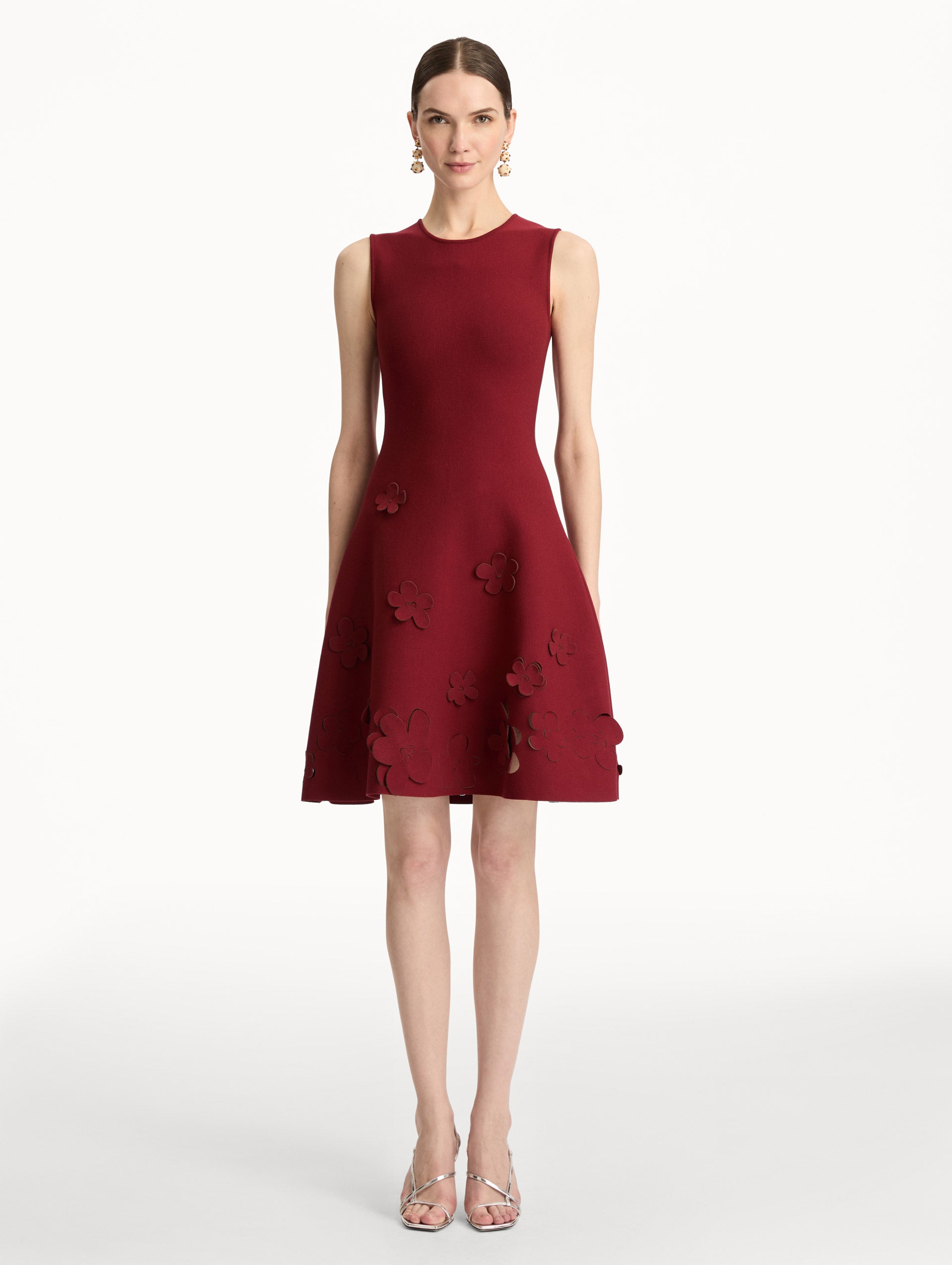 Deep red Laser-Cut Floral Knit Dress featuring a round neckline and floral cutout detailing along the hem. Front View.