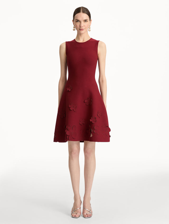 Deep red Laser-Cut Floral Knit Dress featuring a round neckline and floral cutout detailing along the hem. Front View.