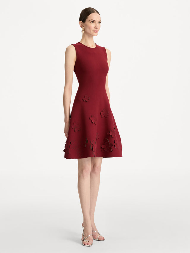 Deep red Laser-Cut Floral Knit Dress featuring a round neckline and floral cutout detailing along the hem. Side View.