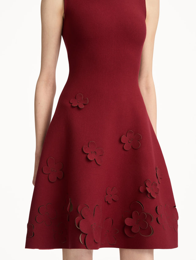 Deep red Laser-Cut Floral Knit Dress featuring a round neckline and floral cutout detailing along the hem. Zoom View.