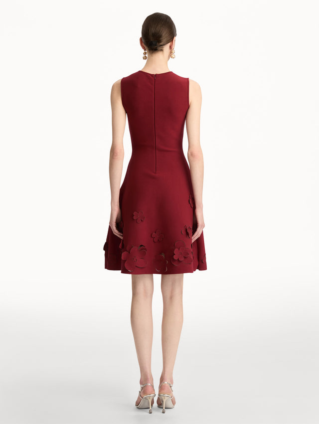 Deep red Laser-Cut Floral Knit Dress featuring a round neckline and floral cutout detailing along the hem. Back View.