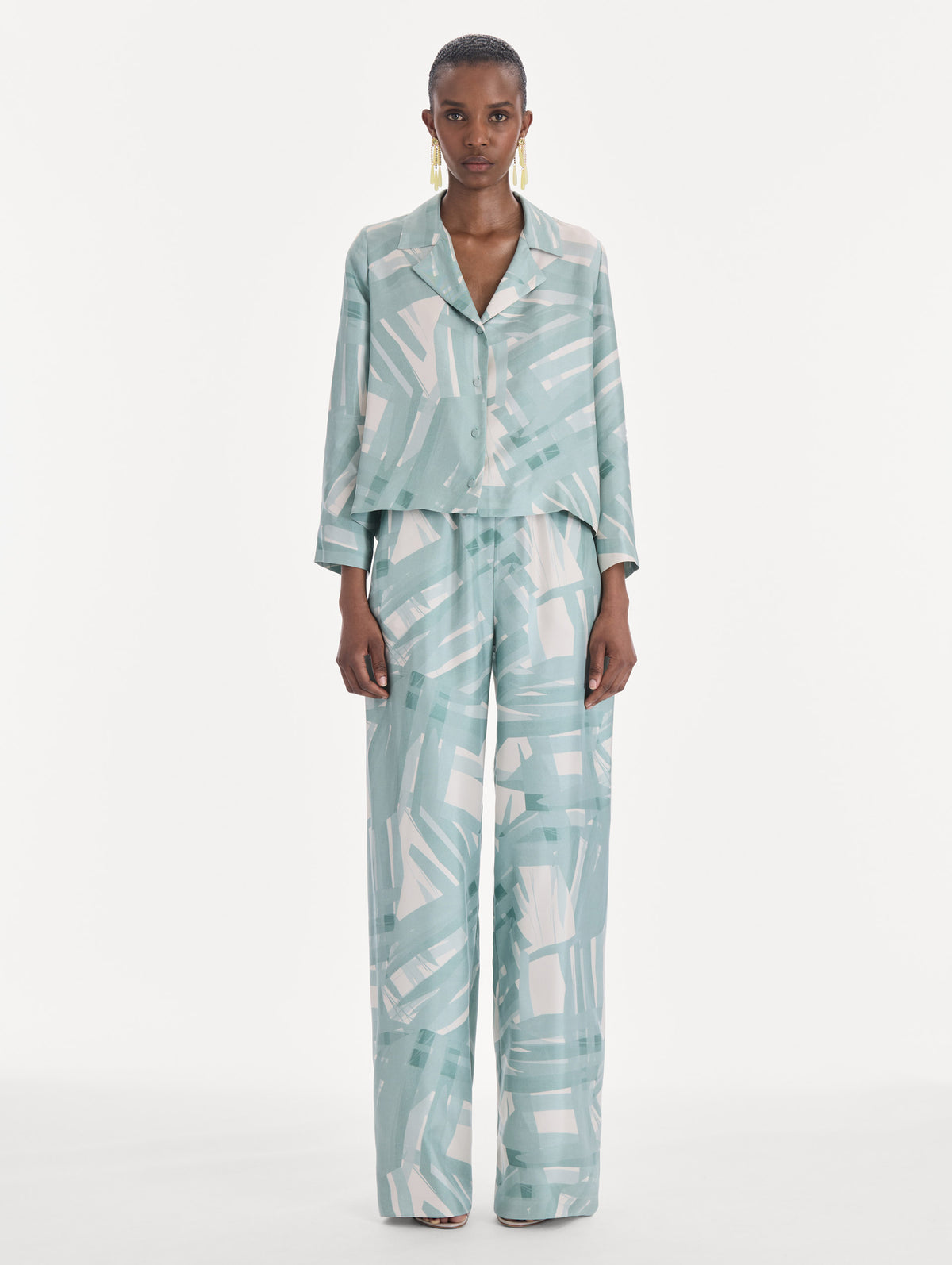 The model is wearing a long sleeve stripey plaid silk twill blouse. Front view.