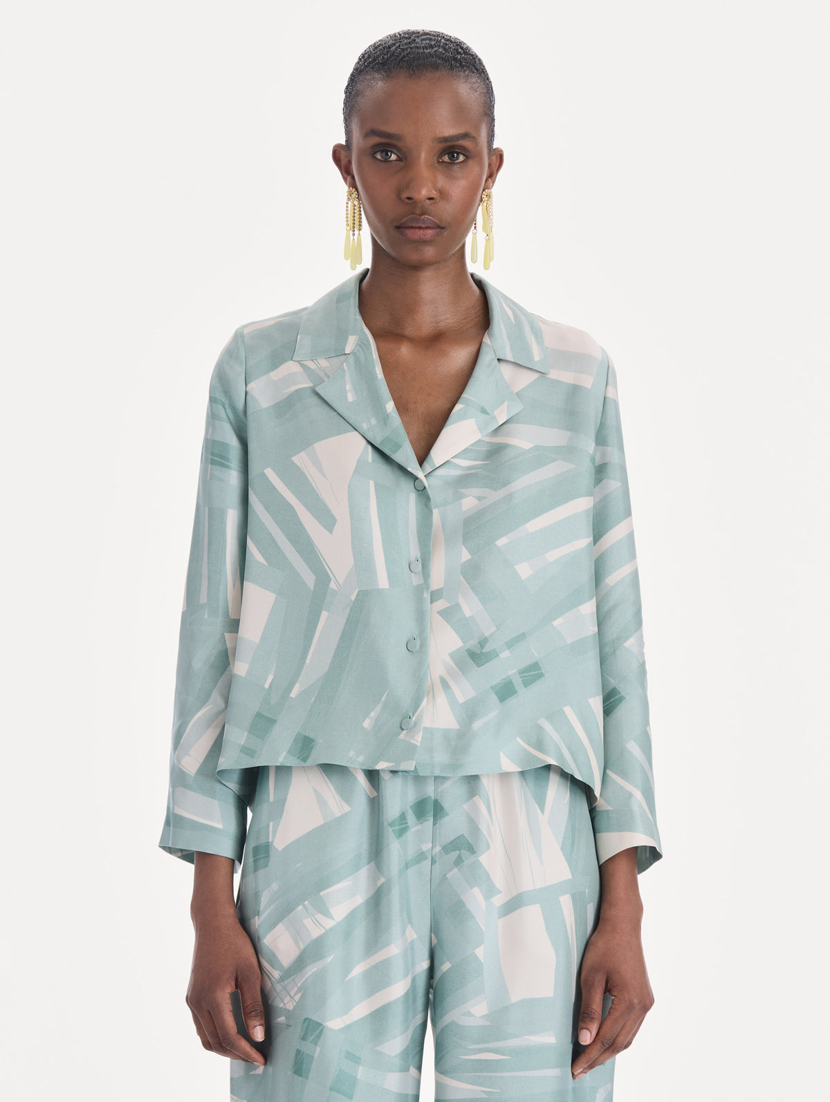 The model is wearing a long sleeve stripey plaid silk twill blouse. Front view.