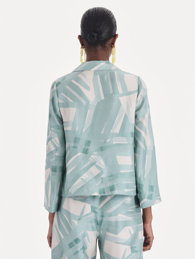 The model is wearing a long sleeve stripey plaid silk twill blouse. Back view.