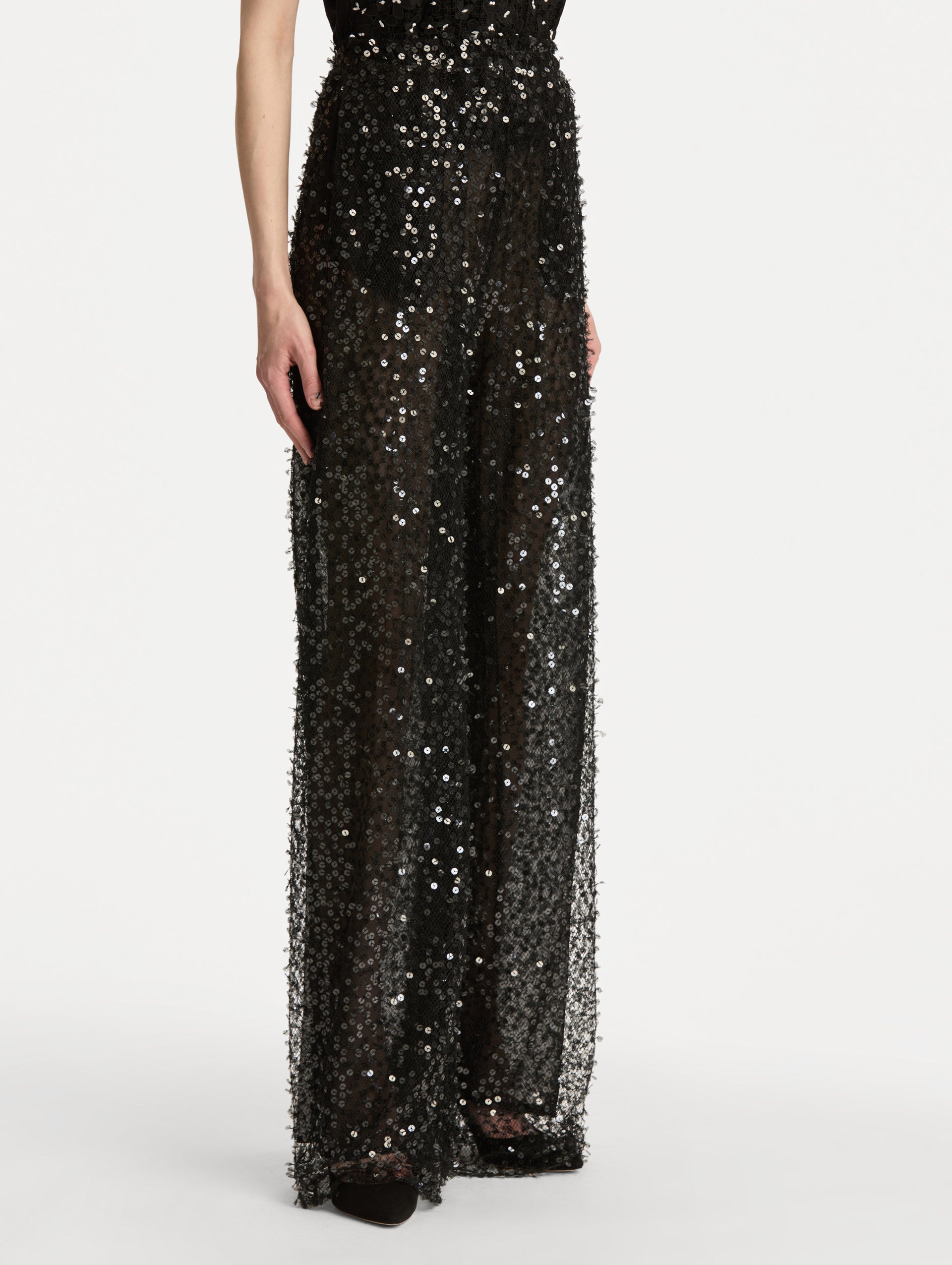 Black Floating Sequin Pant with high waist and wide leg silhouette. Side View. 