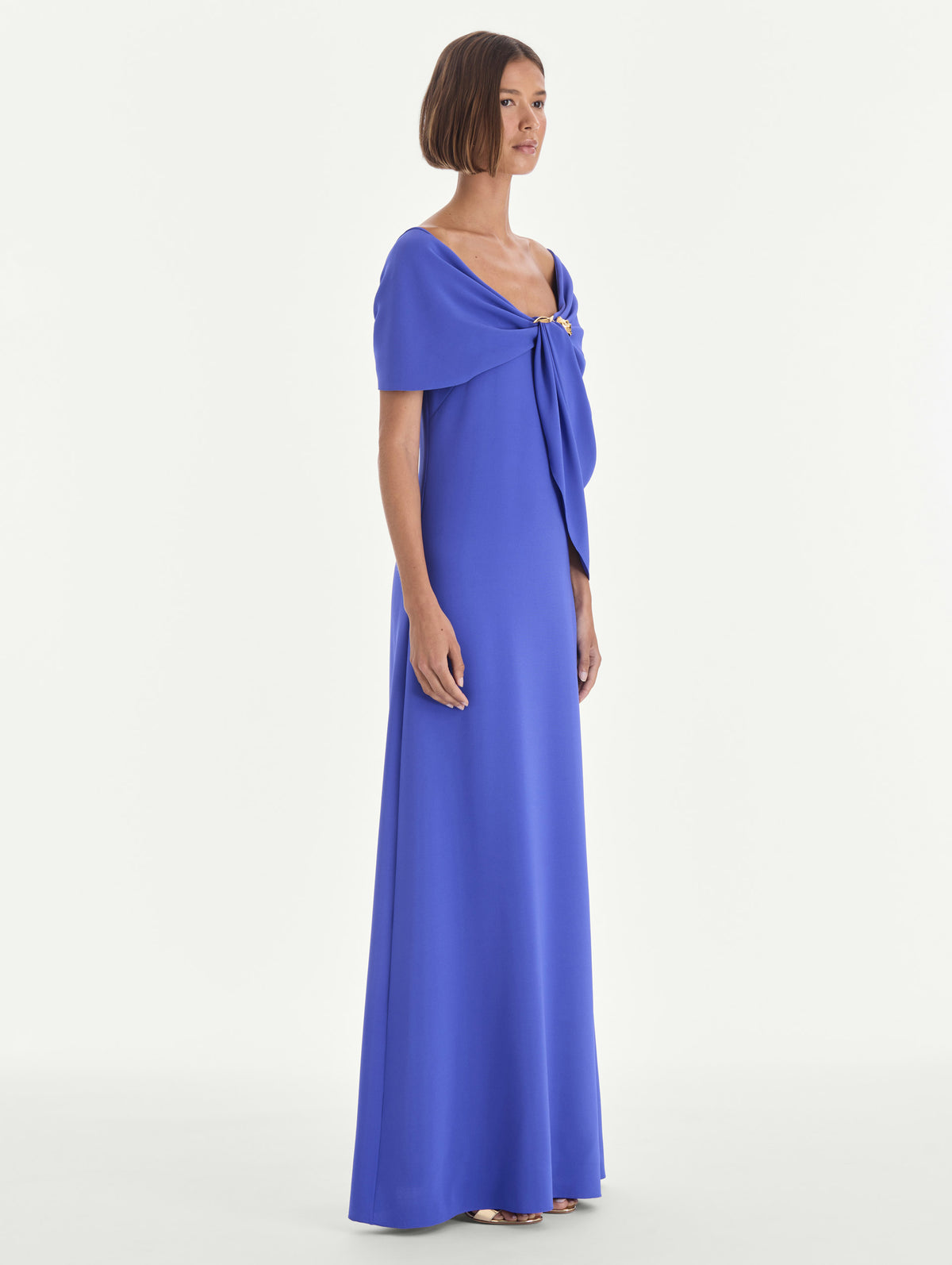 The model is wearing an off shoulder draped detail georgette caftan. Side view.