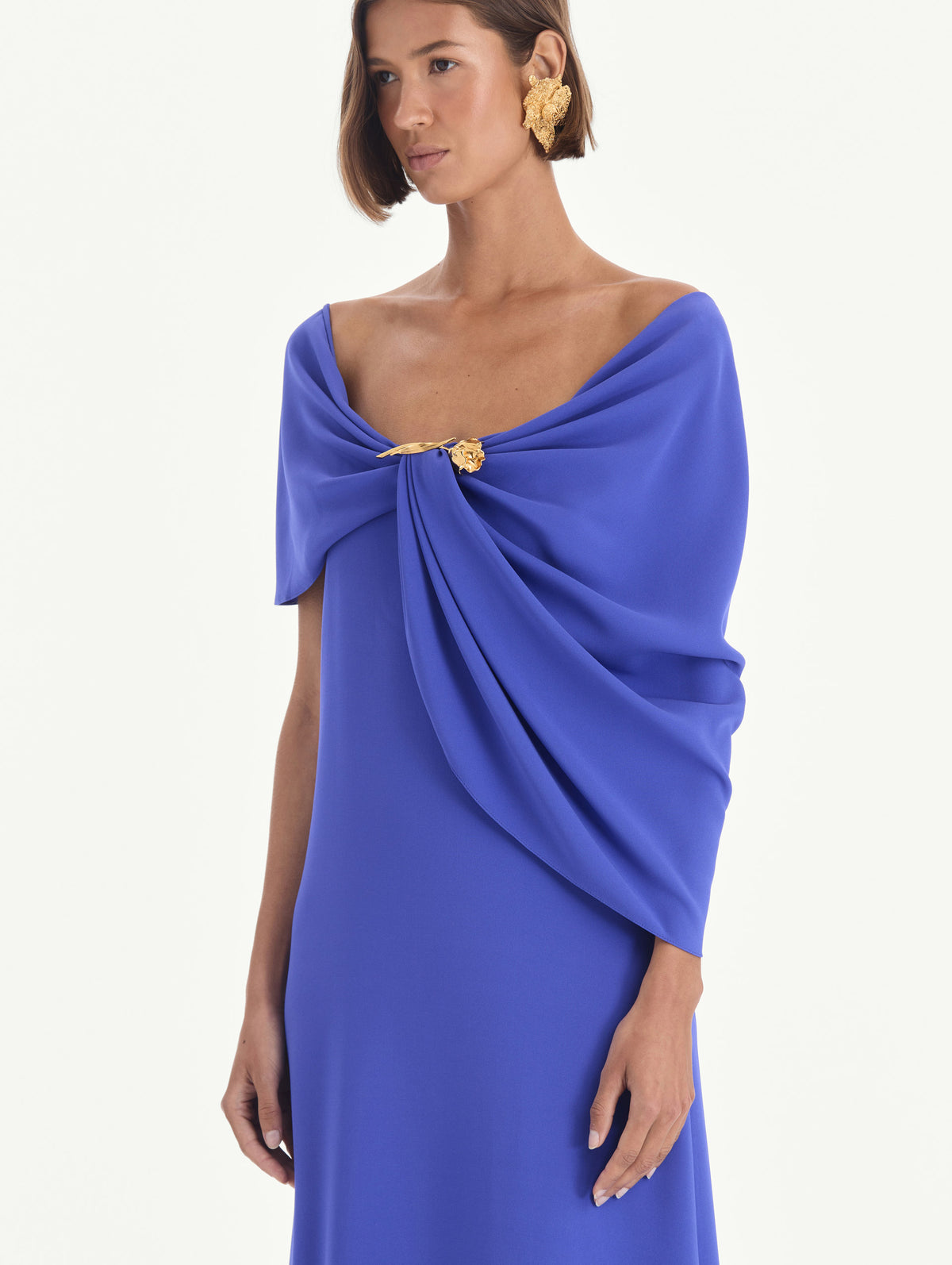 The model is wearing an off shoulder draped detail georgette caftan. Zoom view.